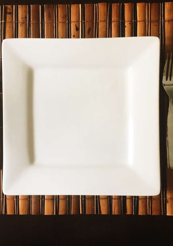 empty plate with fork and spoon on the side