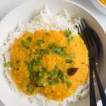 red lentil daal on top of white rice