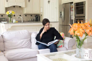 Woman sitting on couch reading