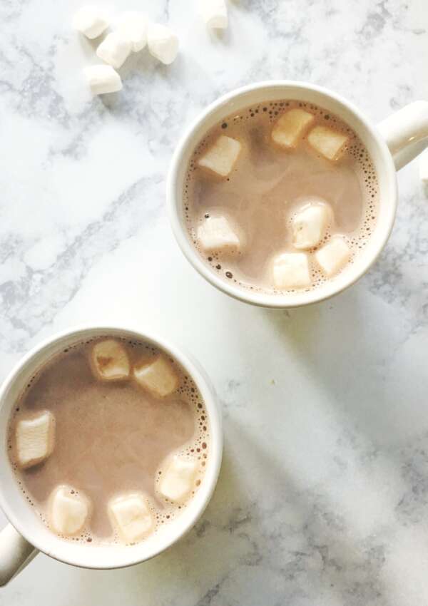 2 mugs with hot cocoa and marshmallows