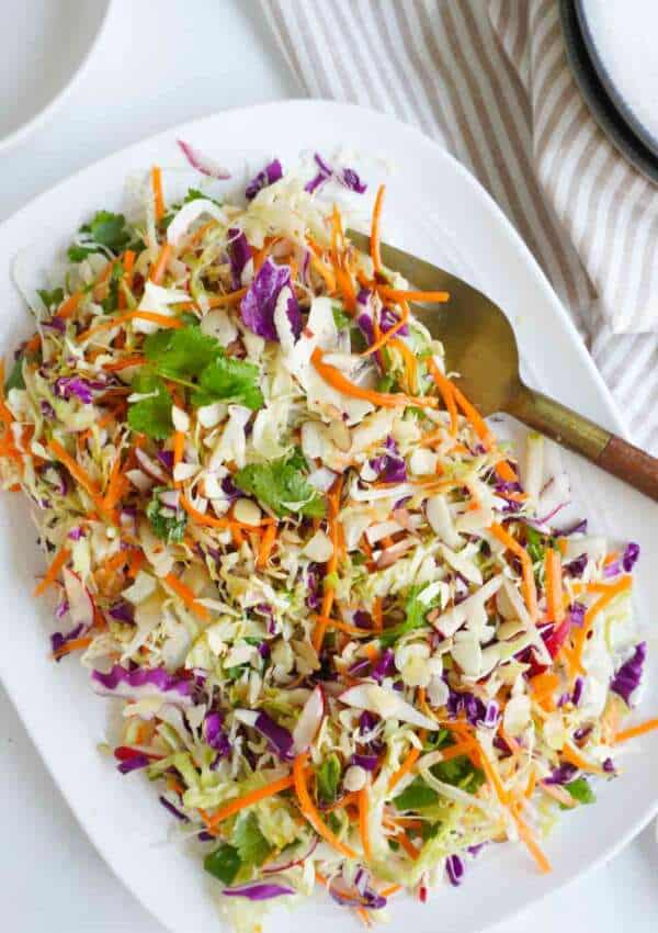 a flat lay of a platter with Thai salad and a serving fork