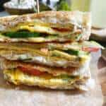 A stack of club sandwiches with a food pick to hold it in place