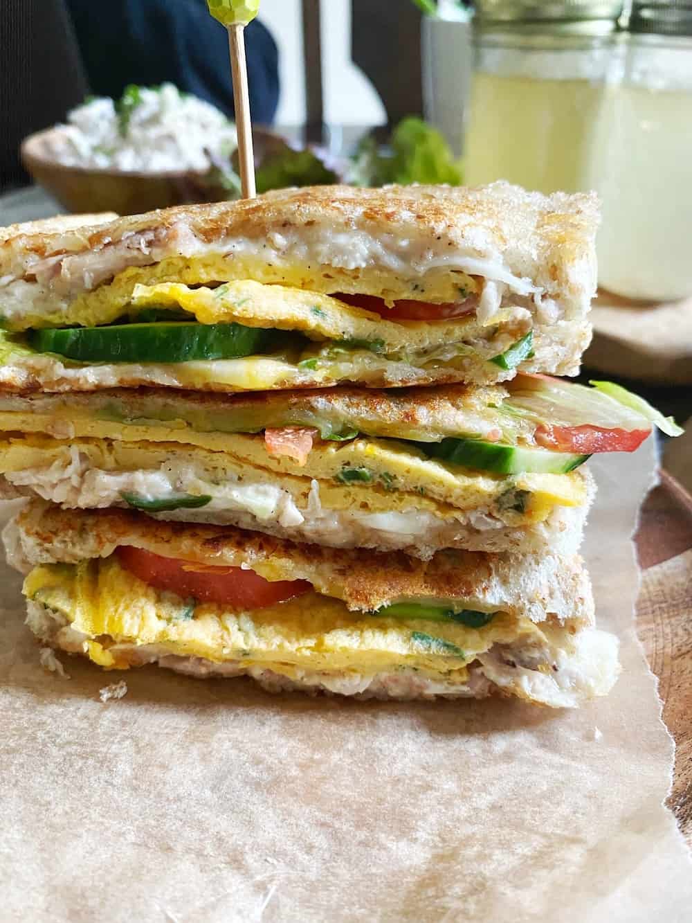 A stack of club sandwiches with a food pick to hold it in place