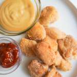 Gluten free Chicken nuggets on a plate with condiments