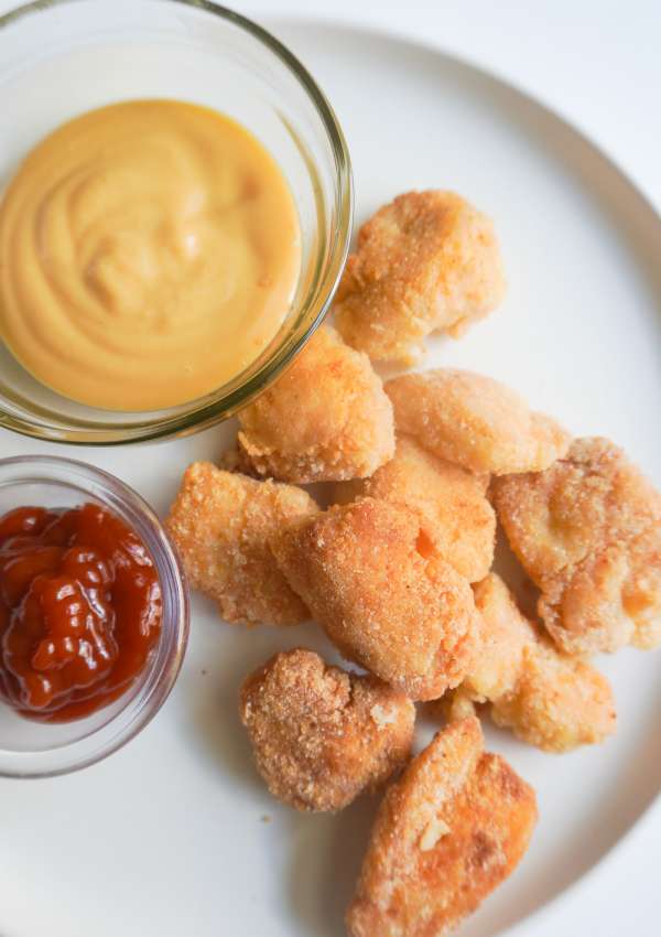 Gluten free Chicken nuggets on a plate with condiments