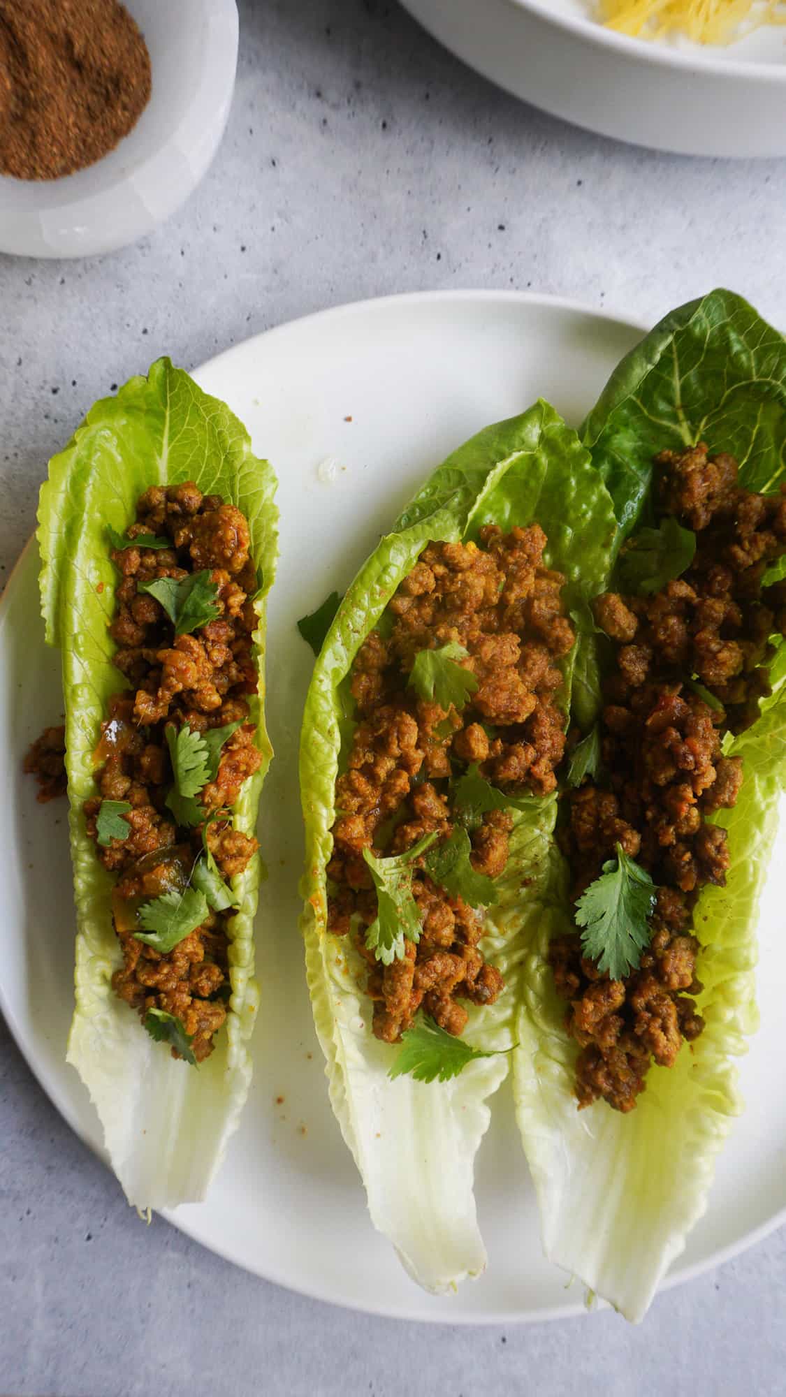 A plate with lettuce cups filled with ground beef