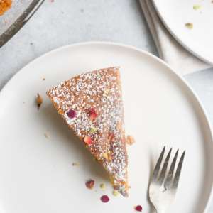 an flat lay of slice of cardamom cake with a fork on a plate