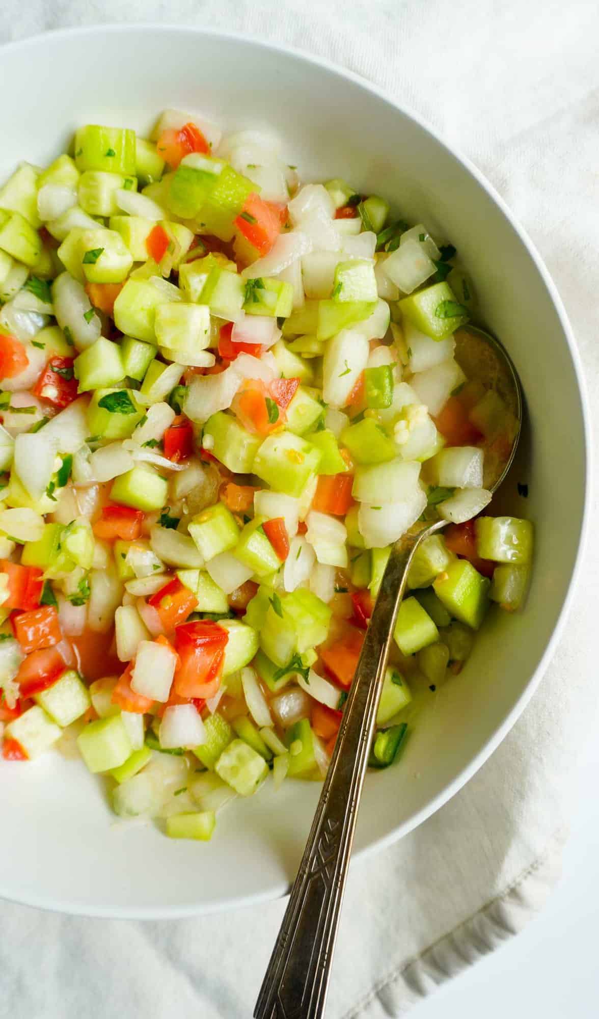 Kachumbar in a bowl with serving spoon