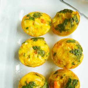 spicy egg mini muffins in a clear meal prep storage container