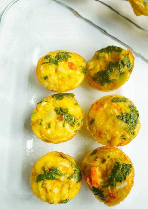 spicy egg mini muffins in a clear meal prep storage container