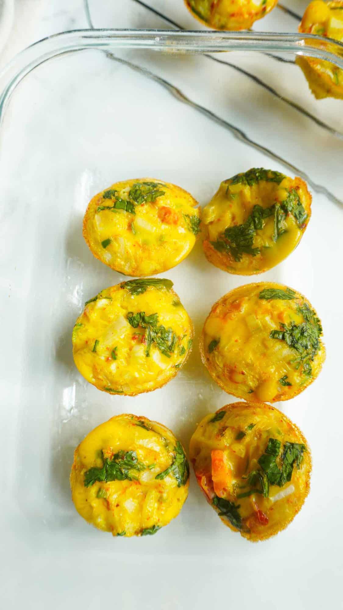 spicy egg mini muffins in a clear meal prep storage container