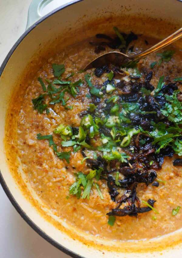 Chicken haleem in a pot with garnish