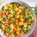 Ariel view of mango chaat in bowl atop a board