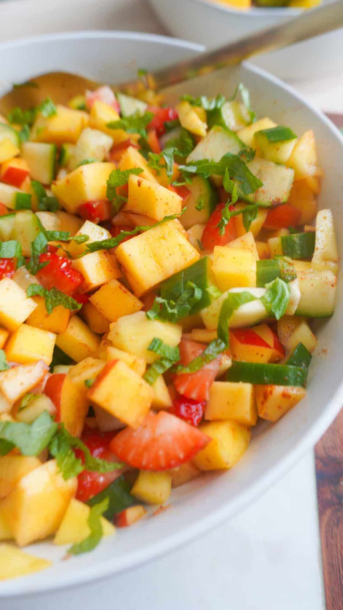 Close up of mango chaat in bowl with spoon