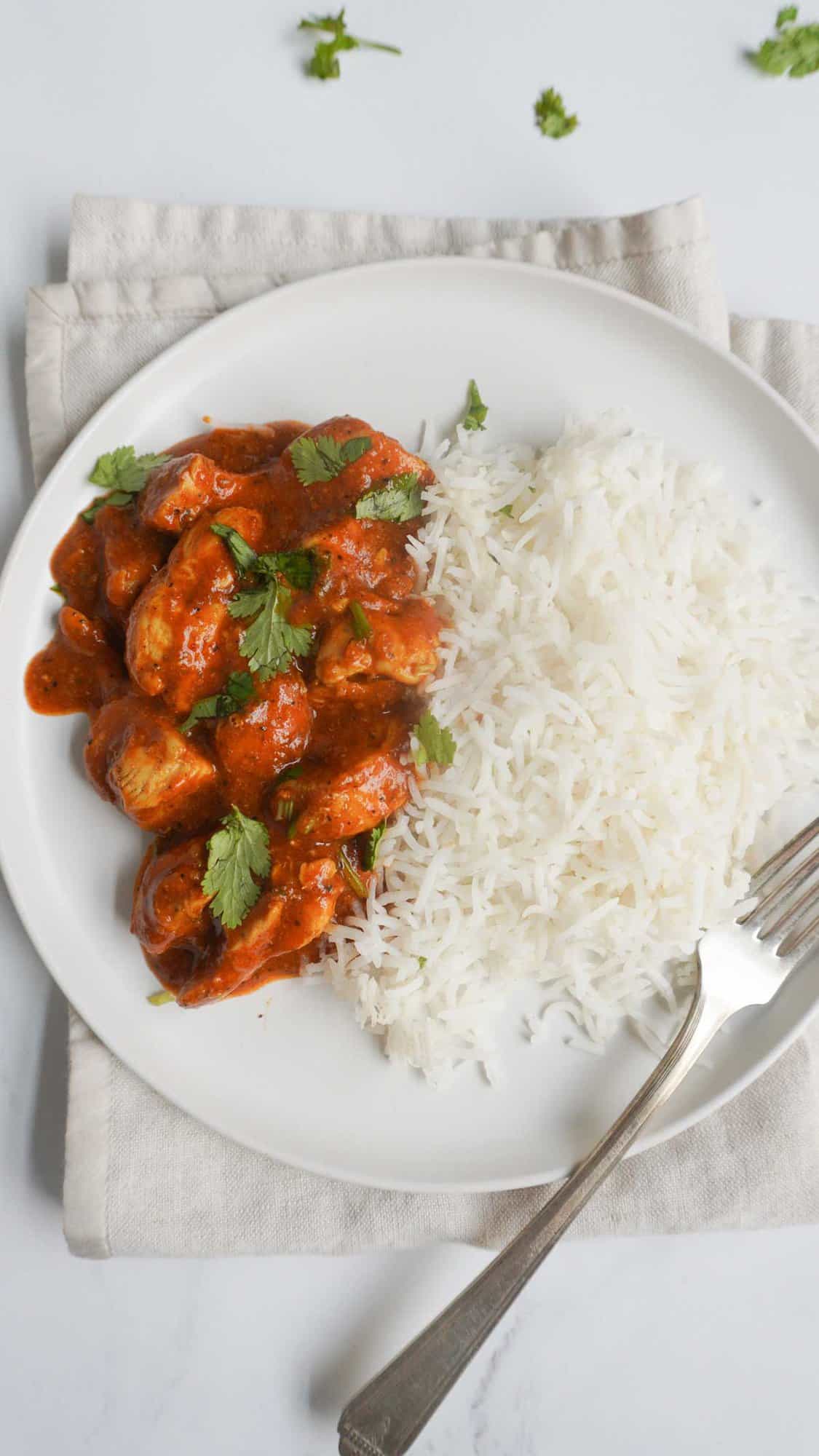 Tandoori Chicken Curry with white rice served in a plate with a fork