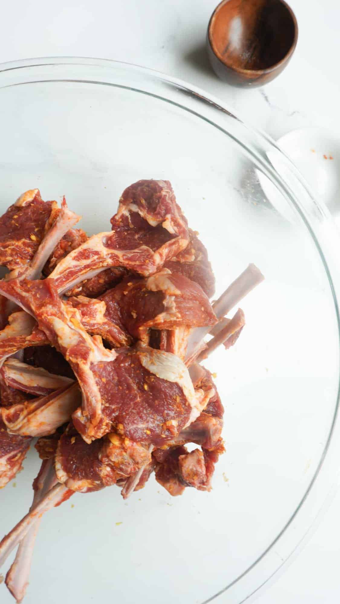 marinated lamb chops in a clear bowl