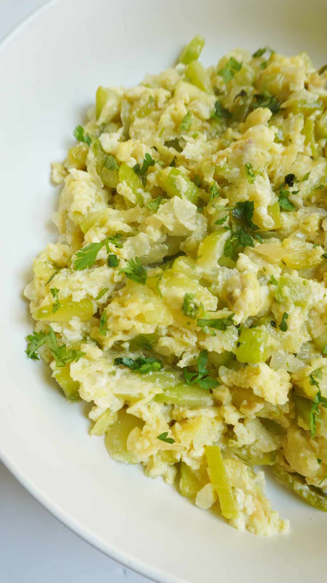 close up of zucchini and scrambled egg curry in a dish