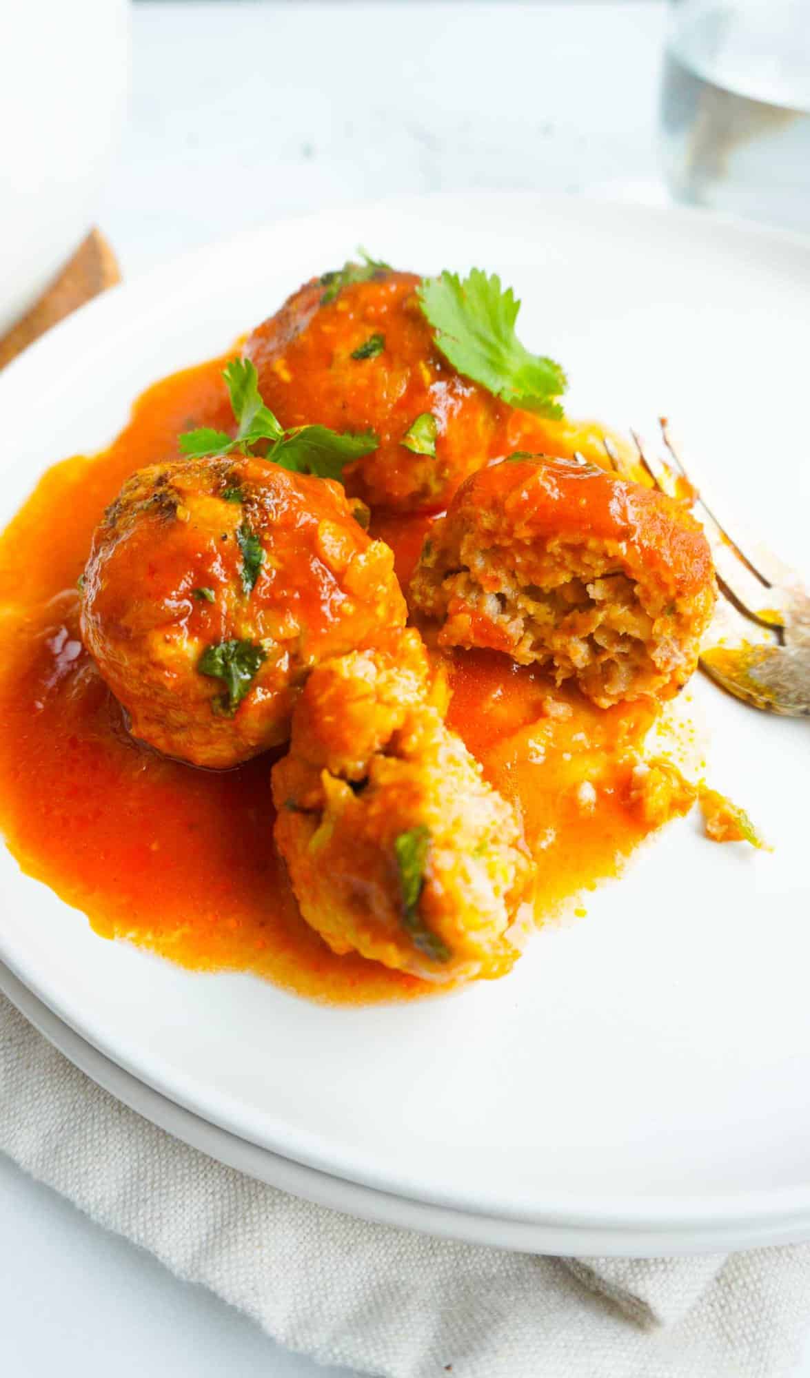 Chicken Kofta Curry on a plate with a fork.