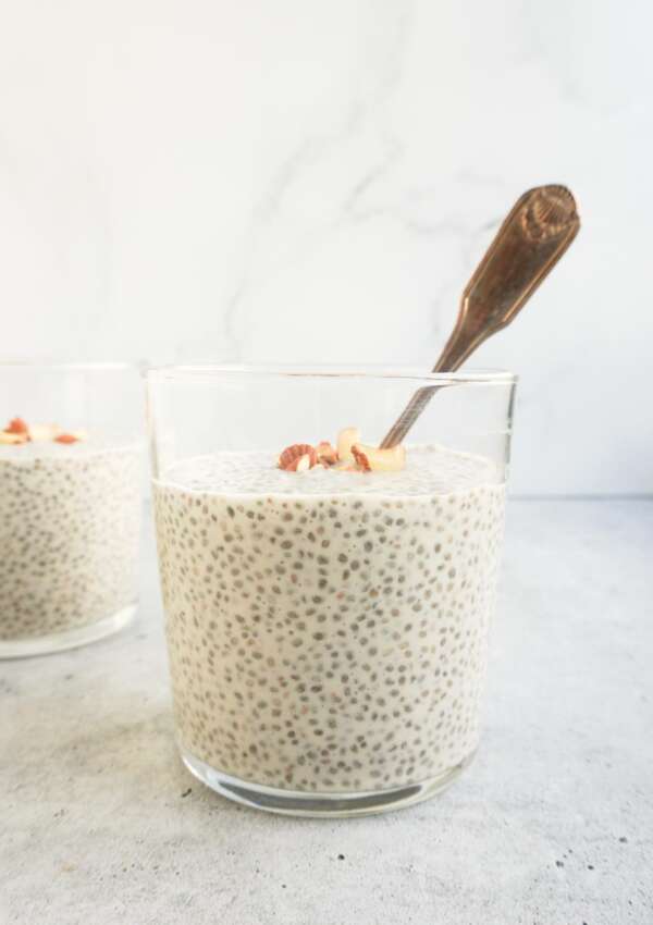 chia kheer in glass cup with a silver spoon