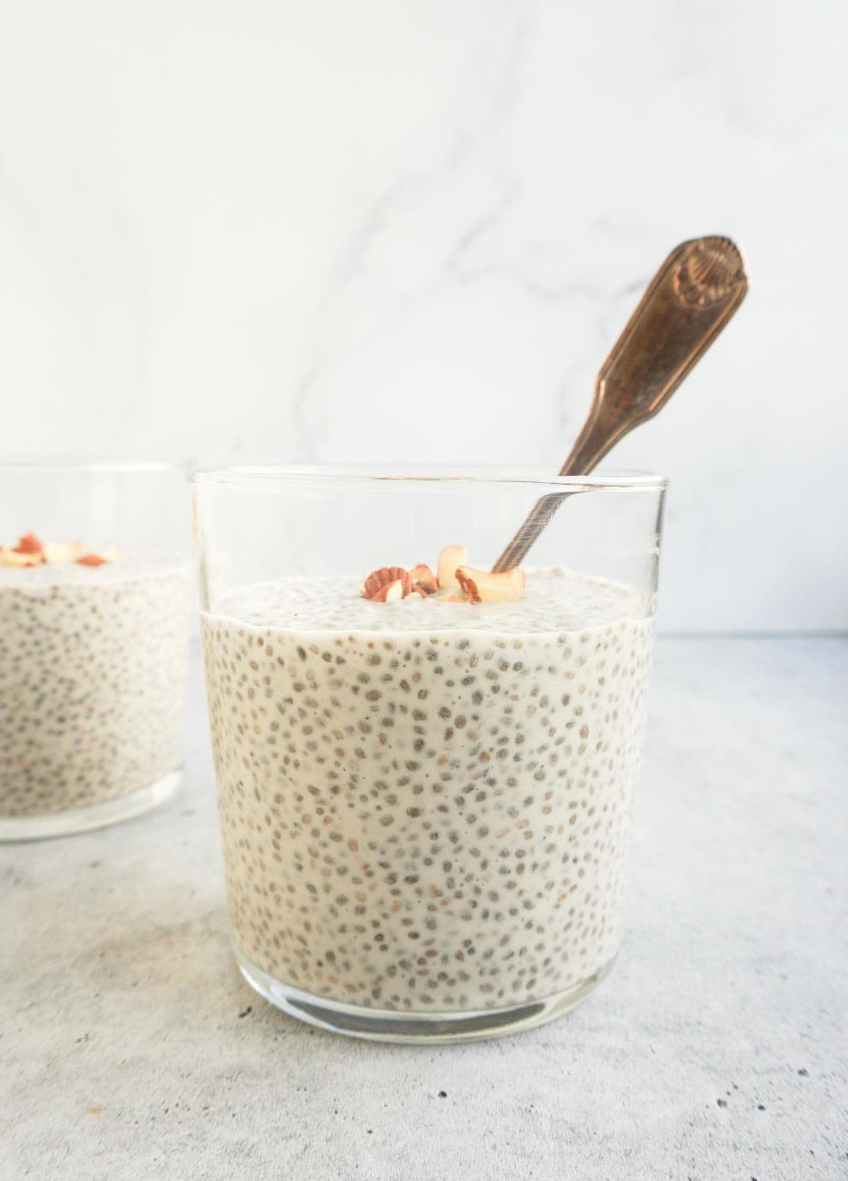 individual chia kheer cups with a spoon 