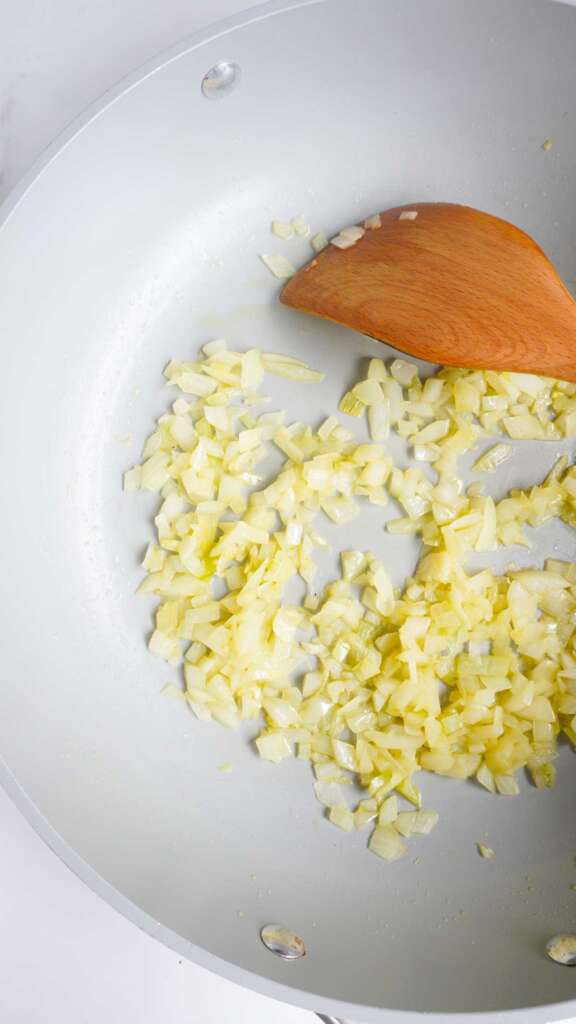 translucent diced onions in pan.