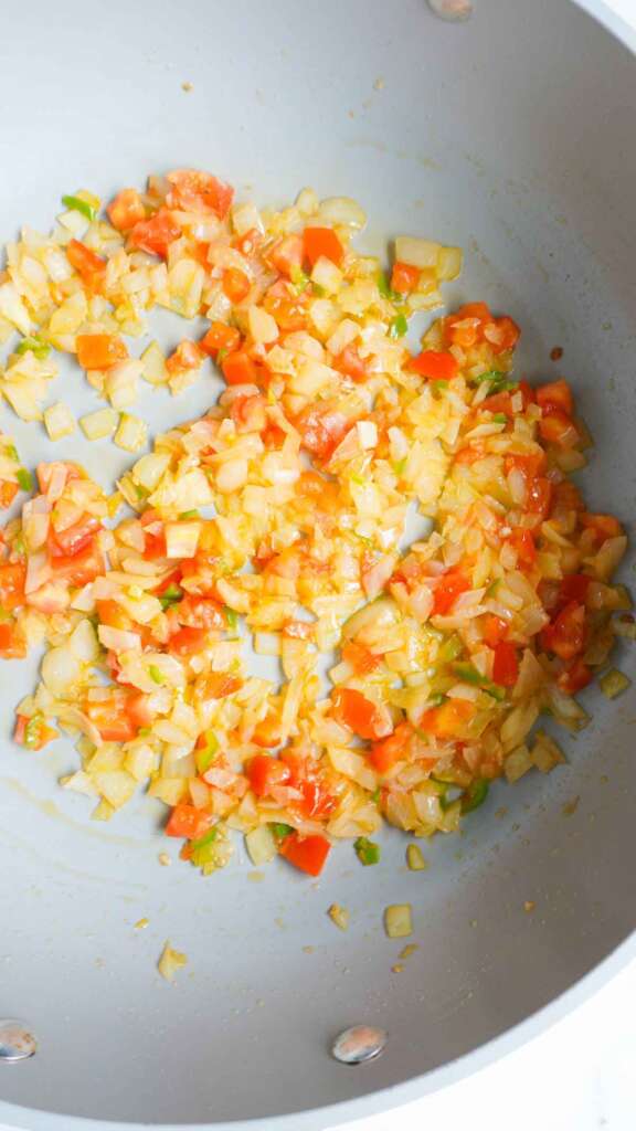 Onions, tomatoes and green chilies sauted in pan.