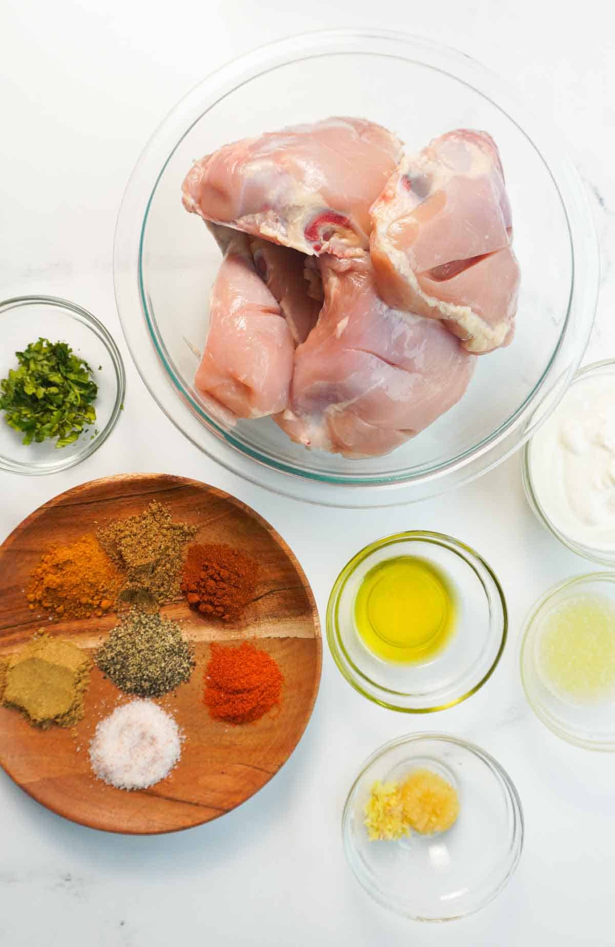 Flat lay of Tandoori chicken ingredients in bowls.