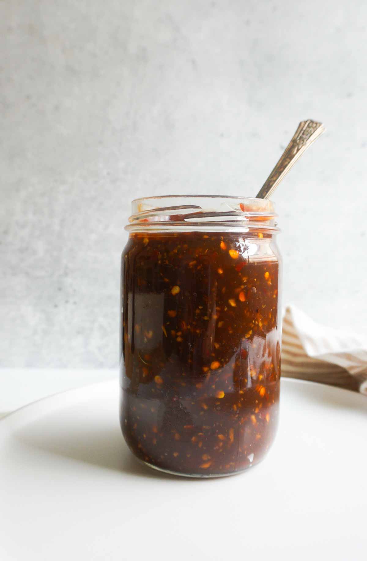 homemade batch prepped teriyaki sauce in jar with spoon