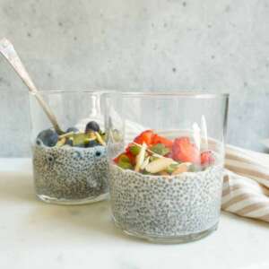 2 jars of chia seed pudding with strawberries and blueberries