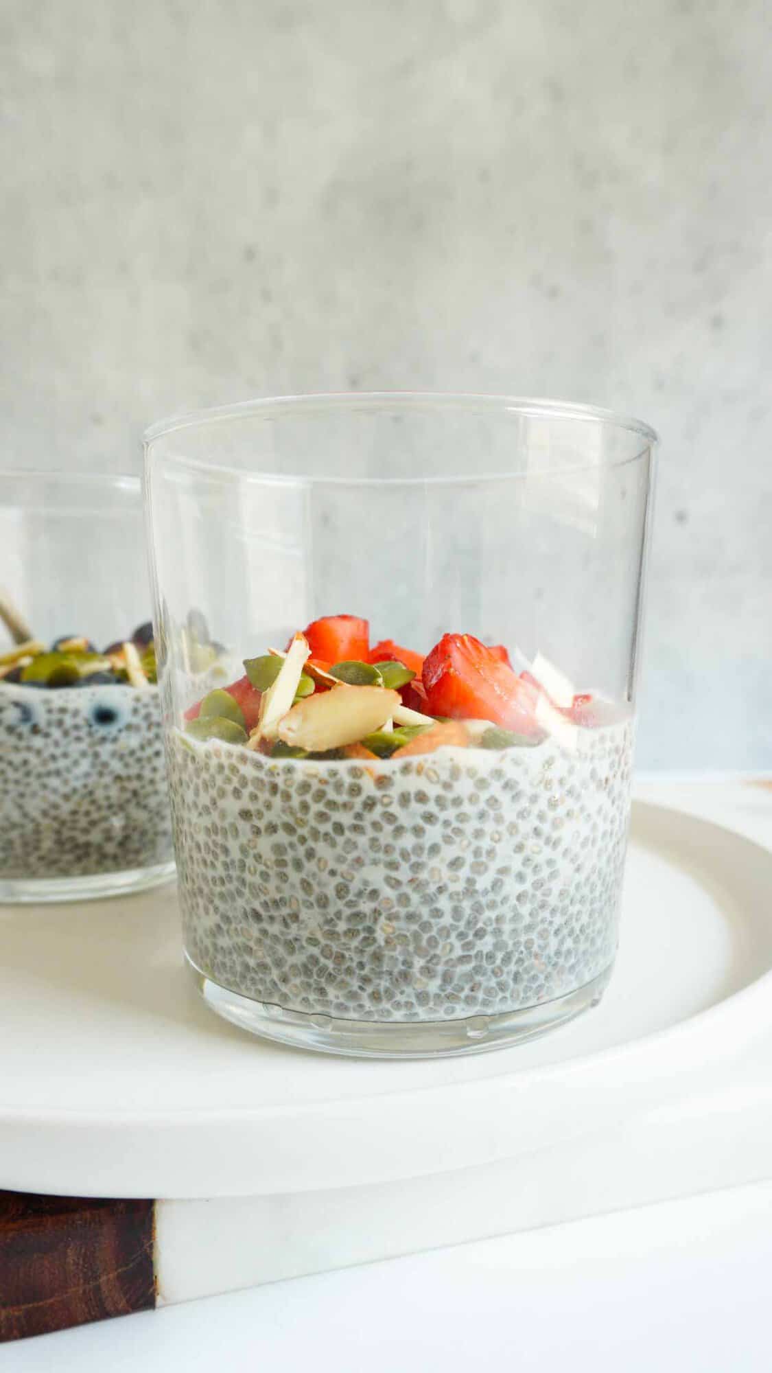 Chia seed pudding with berries and nuts in a jar.