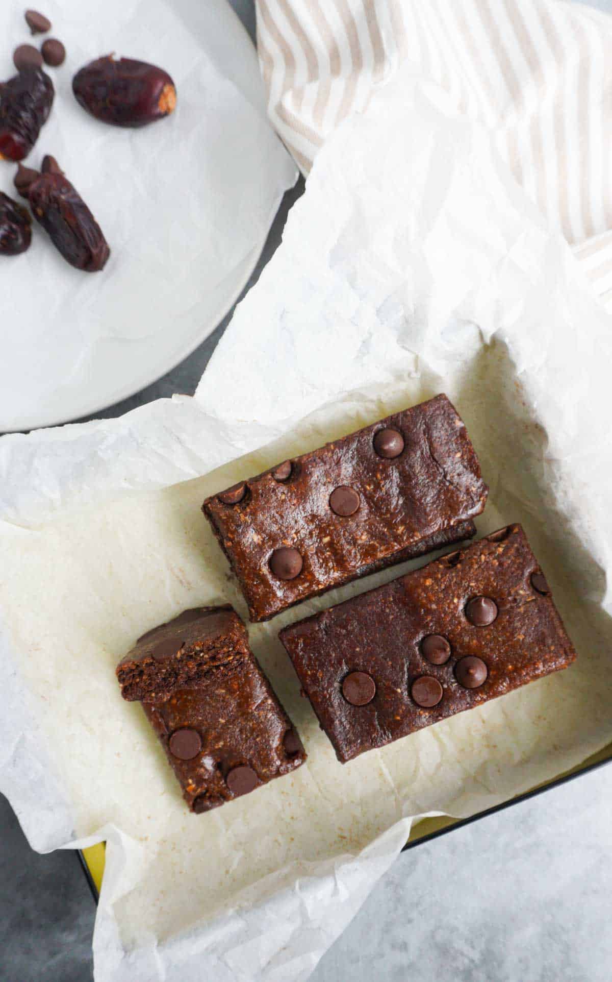A parchment lined box with chocolate date energy bars