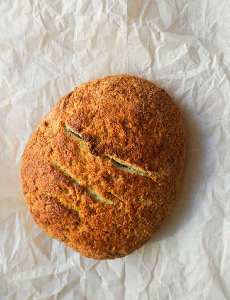 A gluten-free bread loaf on parchment