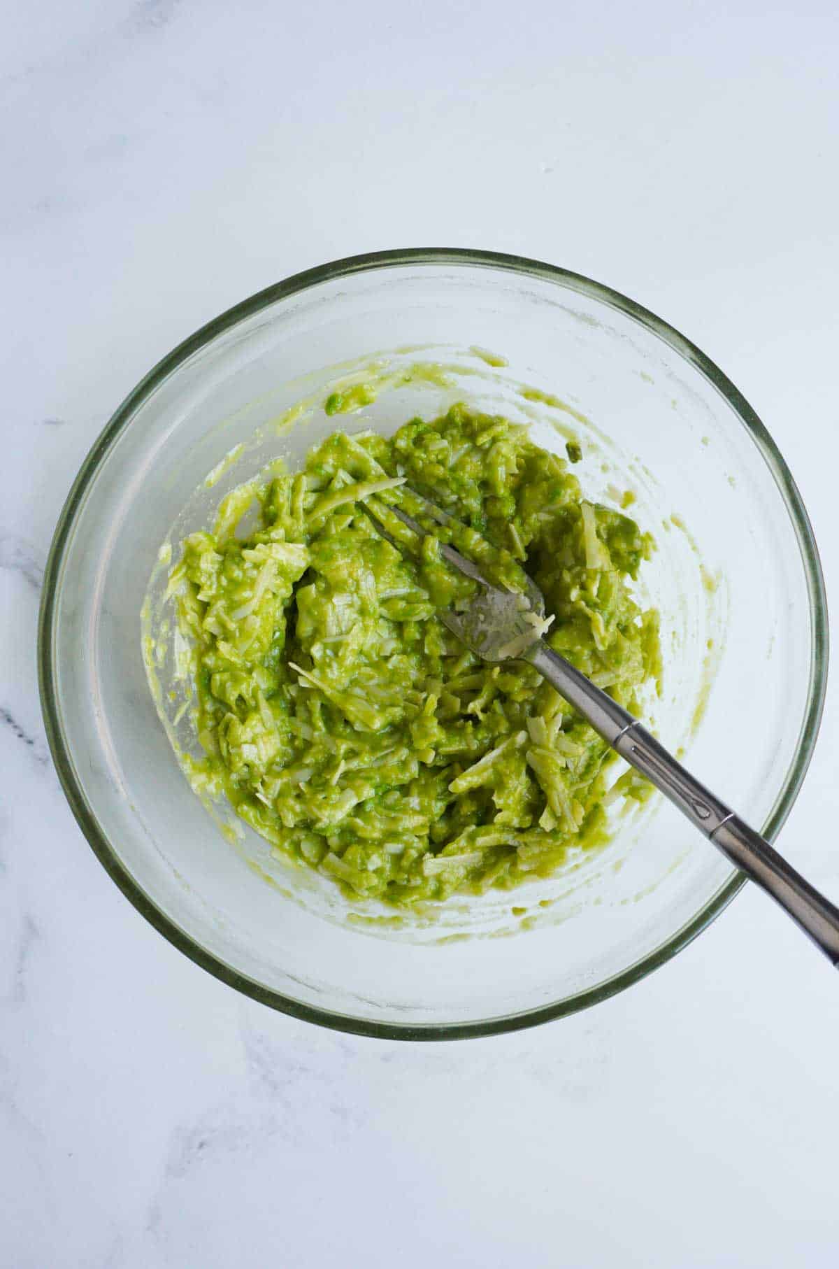 mixed cheese, egg and avocado in a bowl with fork