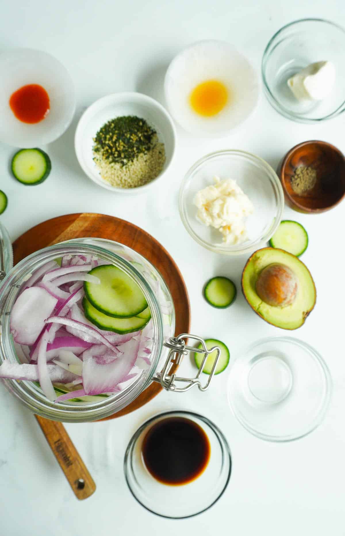 ingredients for cucumber salad in bowls