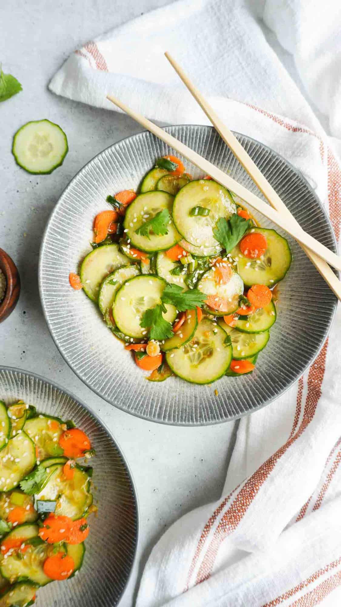 bowls of carrot cucumber salad with chopsticks