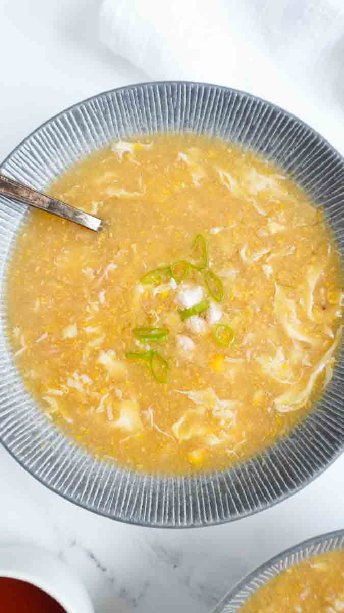 A close up shot of a bowl of chicken corn soup