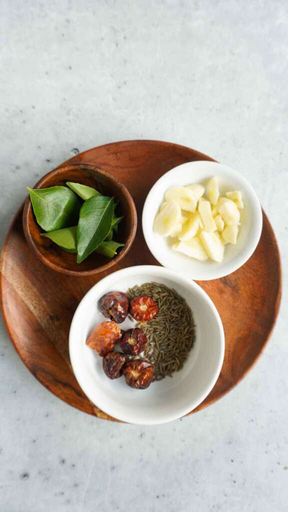 Flat lay of tadka ingredients for black masoor daal
