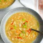 A close up of a bowl of gluten free hot and sour soup and one in the back ground.