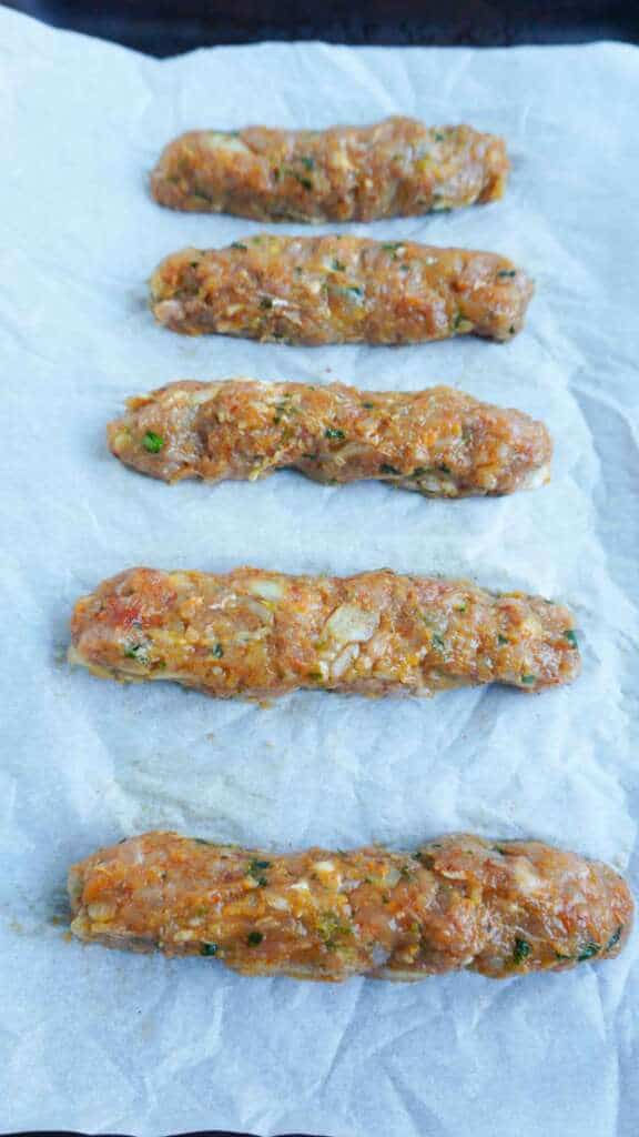 Chicken Seekh Kebab laid out on sheet pan to bake