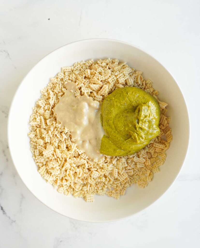 a bowl with chex mix, pistachio butter and tahini