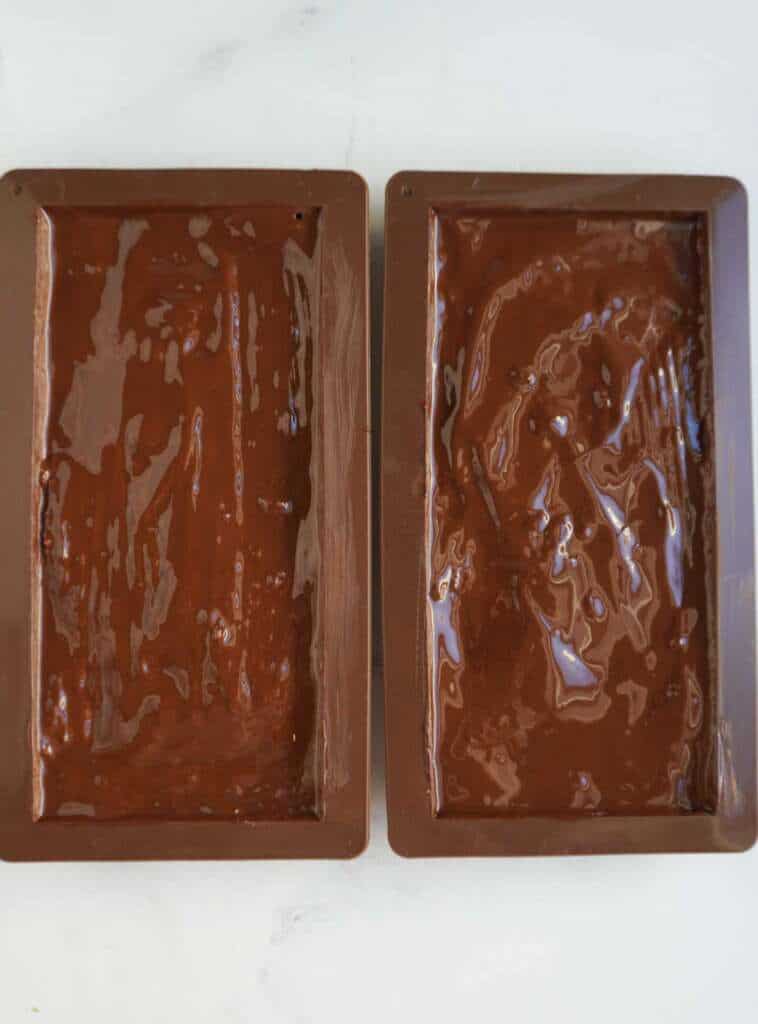 2 chocolate molds filled with chocolate 