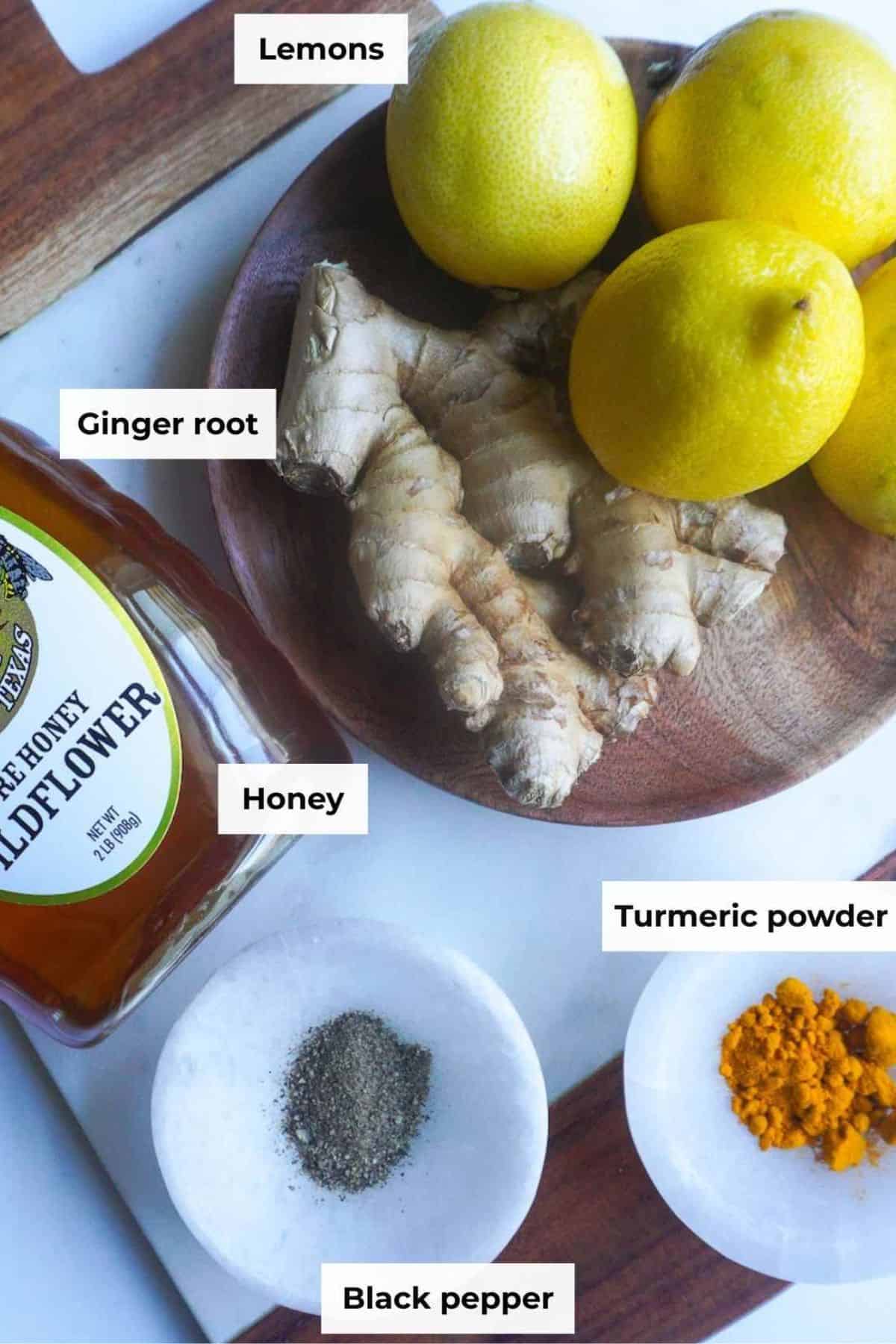 Ingredients for lemon honey ginger syrup on a light background.