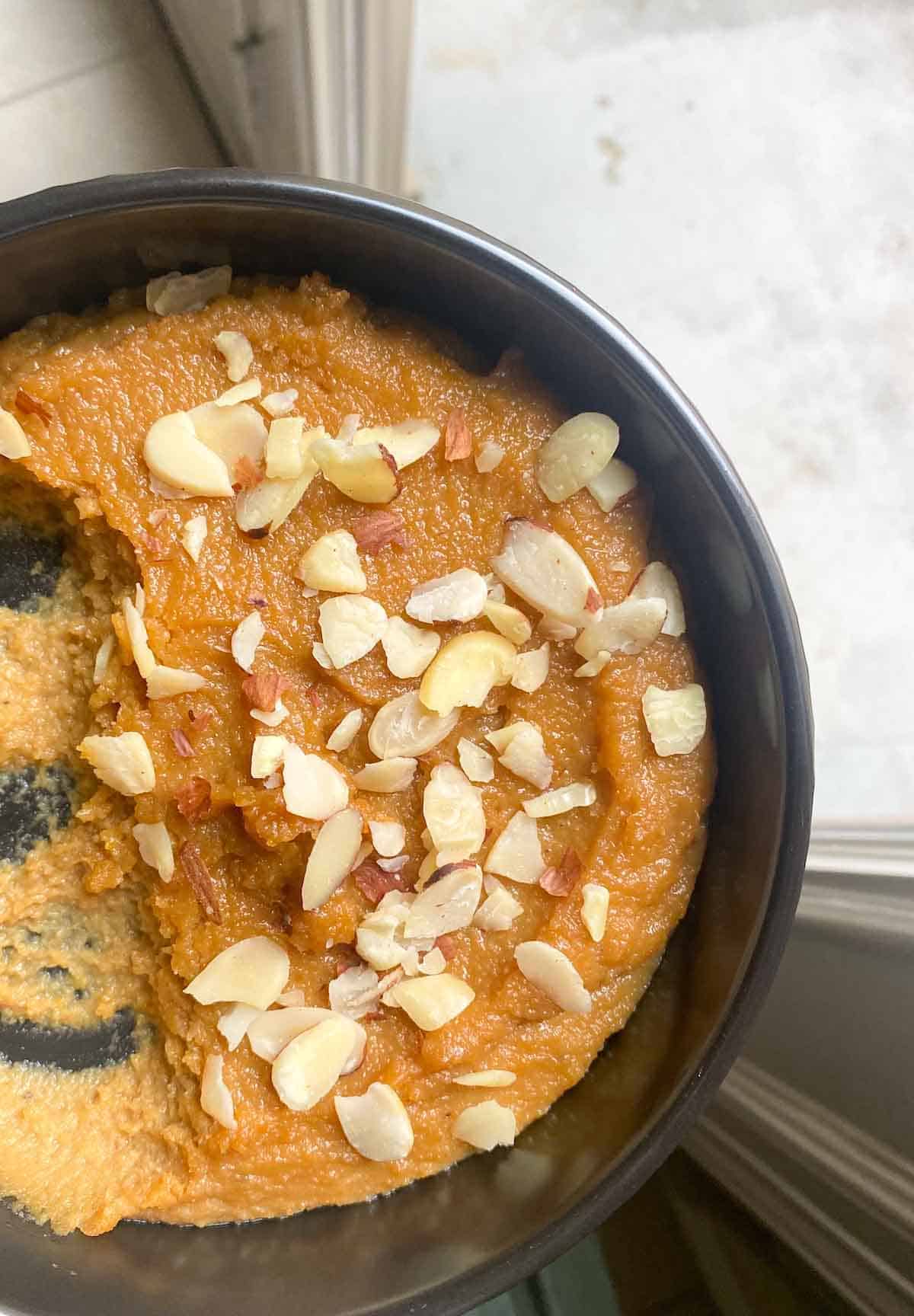 A bowl of almond halwa with slivered almonds
