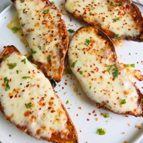 Sweet potato mozzarella halves on a white plate.